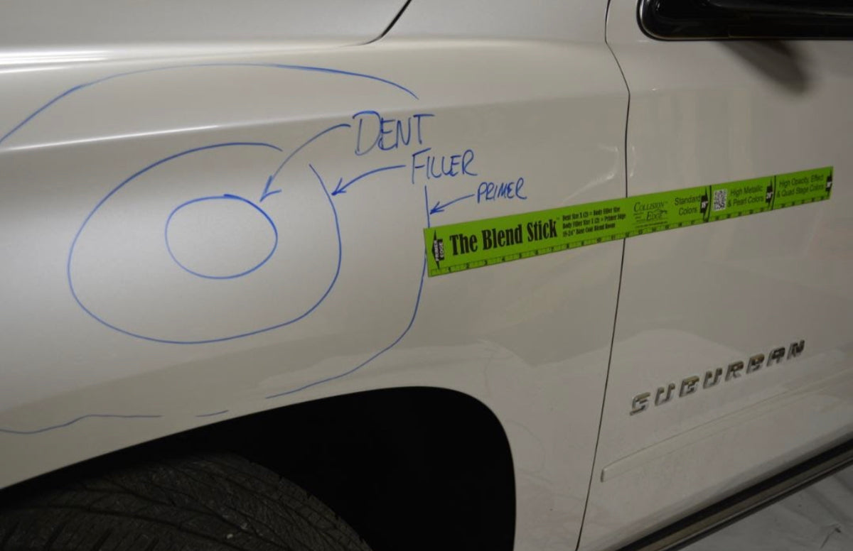 Blend Stick positioned across a vehicle panel to evaluate repair and blend space